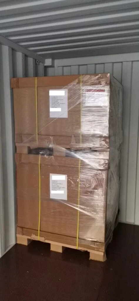 The shipping container is packed to the edge! Below are photos showing the progress of loading the first two pallets and then the final pallets.