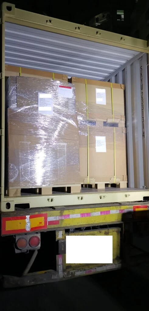 The shipping container is packed to the edge! Below are photos showing the progress of loading the first two pallets and then the final pallets.