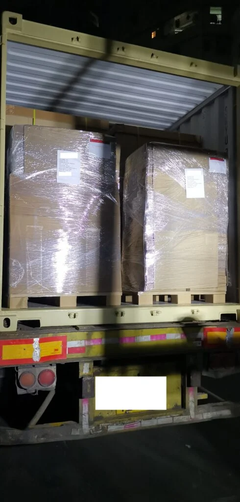 The shipping container is packed to the edge! Below are photos showing the progress of loading the first two pallets and then the final pallets.
