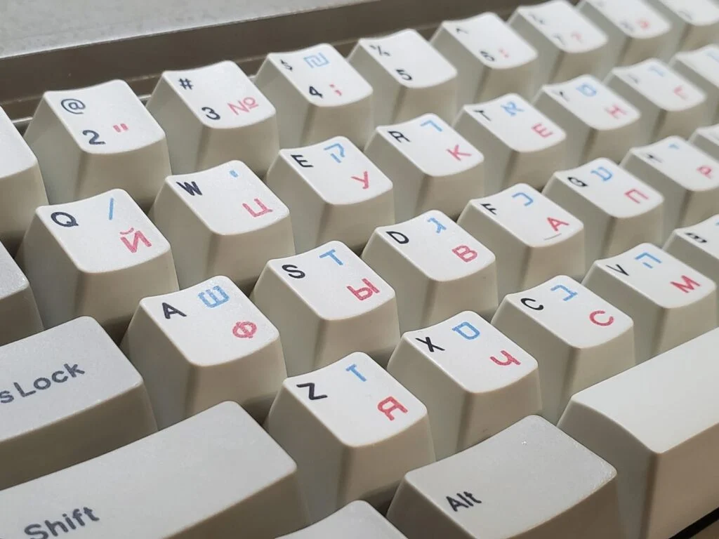 The factory can even do green, red, and blue for the sublimation text/graphics and multiple colors can be printed at the same time and on the same keycap, as shown in the three Russian-Hebrew-English photos below. If anyone wants one-off sets in various colors it is possible, though some sublimation colors come out better than others and you’d have to make them to find out. So far green, blue, and red have come out nicely.
