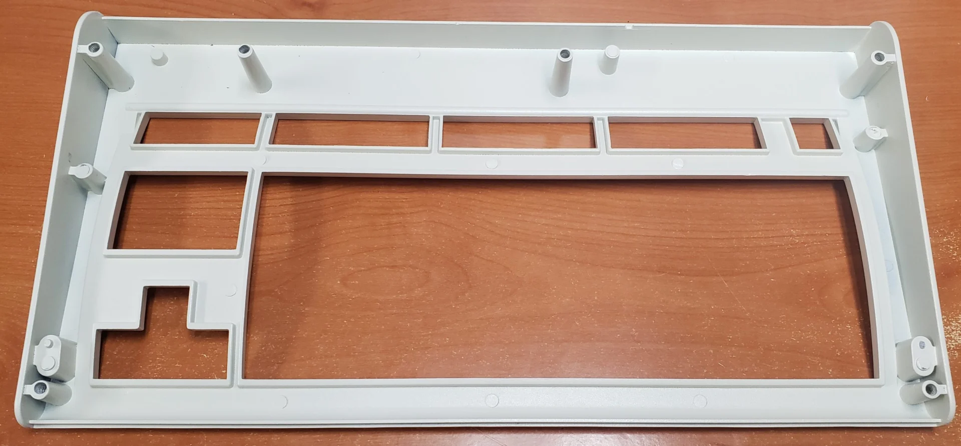 Here’s a photo of the bottom case part, as installed on a Classic M Style case FSSK. Please note that these photos are of prototypes whose case bottoms were rejected because the screws were improperly recessed and the bottom did not properly align with the contours of the case top (the bolts should be fully recessed and flush with the case bottom and the case bottom should not extend beyond the contours of the case top, and the parts should line up in the front and back though they do not in the sample). The tops had other QC issues as noted in a prior post (casting defects, mold lines, improperly drilled holes for the screws, etc.). The pair of adjacent holes on the bottom are for mounting a solenoid, which can now be done directly and the L bracket mount is no longer needed. These holes should have been recessed so the screws do not stick out of the bottom. The P clip and solenoid driver have individual, dedicated mounting posts inside the keyboard, on the case top.