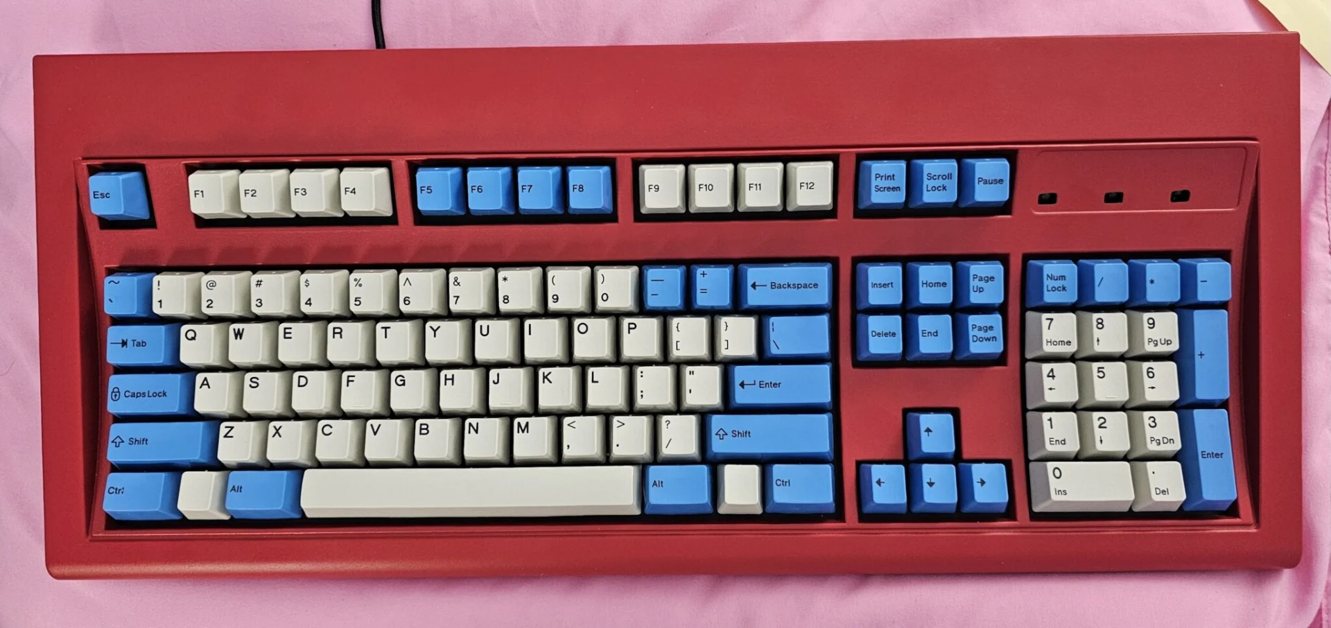 With permission I am sharing a customized keyboard “setup in progress” photo from a new Model F user who has asked that the photo be credited to his first name Mike. I very much like the blue and pearl keycap combination, which is different from the regular all blue or pearl and pebble keycap combinations that are currently available. Additionally this combination looks nice as installed with a True Red case.