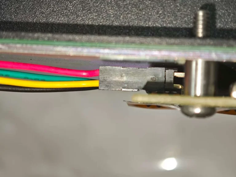 After that, install your solenoid driver and solenoid (optional add-ons). To do this, follow the instructions in the Model F solenoid section while paying particular attention to the photo below showing the beam spring case and controller bottom side. The only differences are that you are using two countersunk screws to attach the solenoid to the case bottom and you are attaching the solenoid driver to the bottom case instead of the top case, using the large countersunk screw in your kit. Between the solenoid driver PCB and the case, insert one of the rubber spacers. Install a nut on top of the solenoid driver. With regard to the orientation of the solenoid driver cable (to avoid destroying your solenoid driver), the red wire of the cable should be closest to that top edge (same for both xwhatsit and Leyden Jar). To be safe you can remove the 4 screws of the top inner assembly to better see the controller.